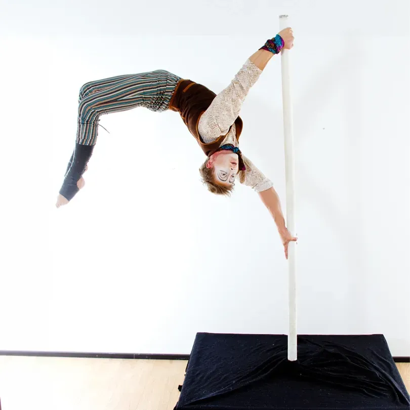 Milanus Circus, Miami, FL, pole performer with back bend.