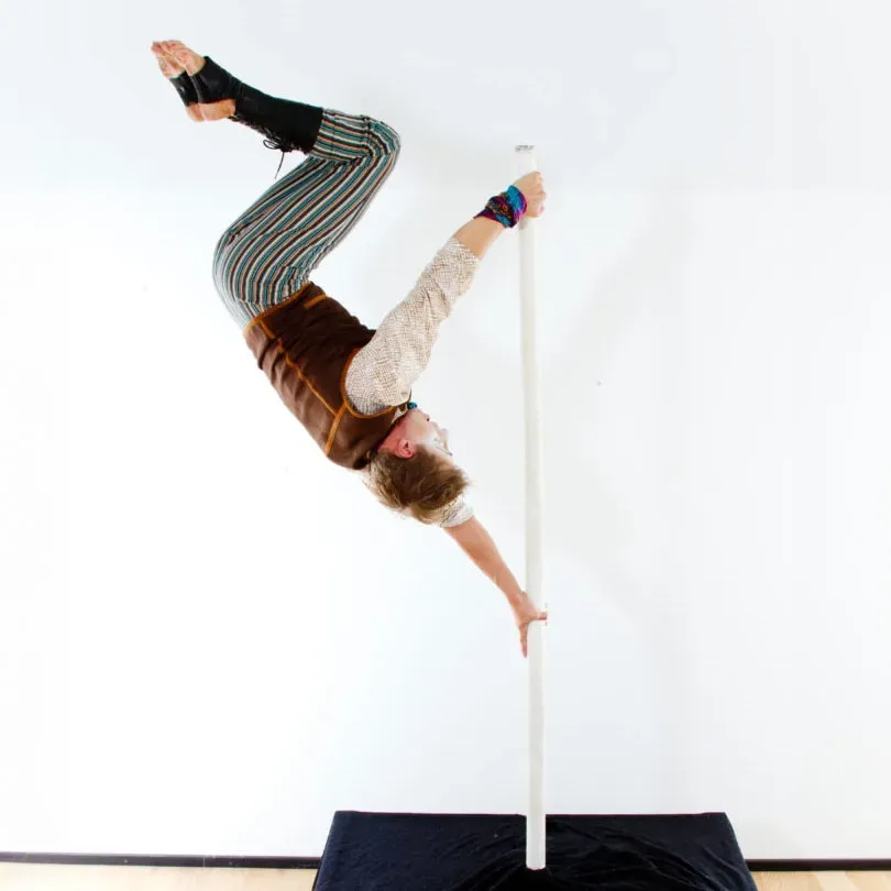 Milanus Circus, Miami, FL, pole entertainer with inverted position.