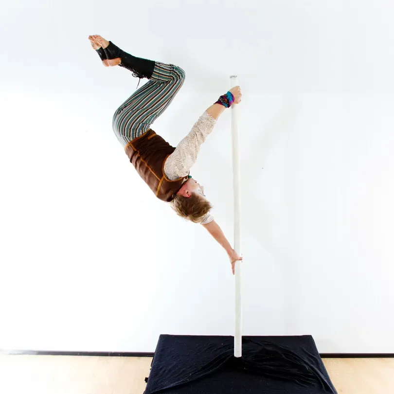 Milanus Circus, Miami, FL, pole entertainer.