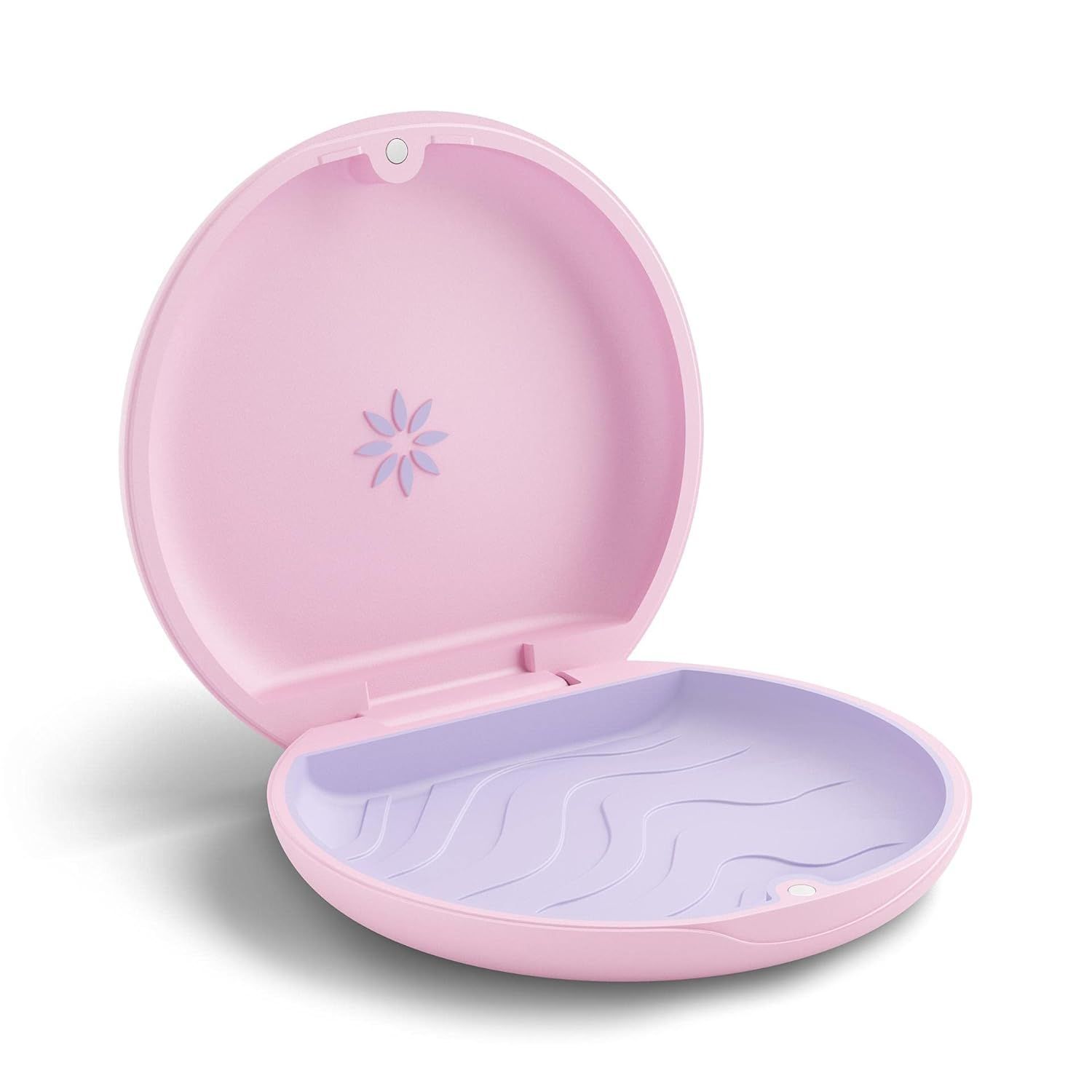 An open, round, light pink orthodontic aligner case with a lavender interior and a small flower icon inside the lid.