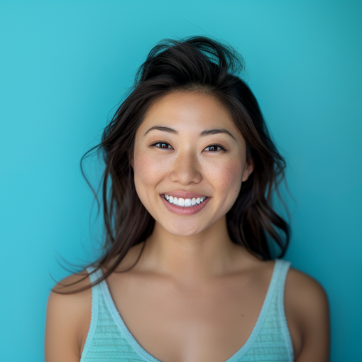 A woman is smiling in front of a blue background