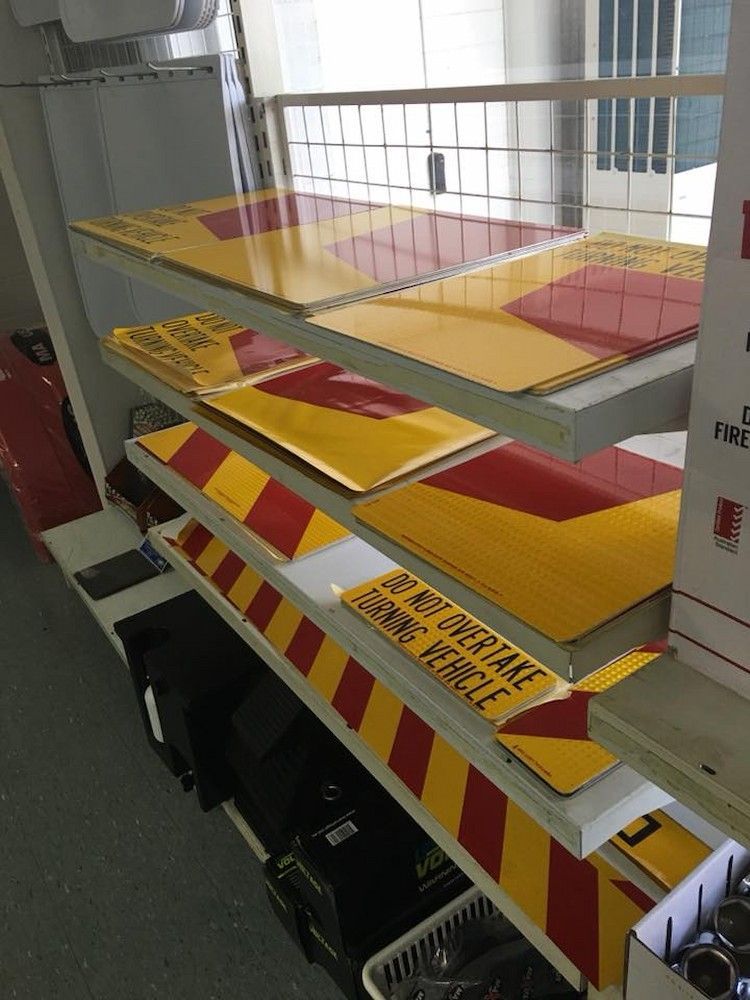 A Shelf With Yellow and Red Signs That Say No Overtake Fire Force — BayZoil Truck & Auto Spares in Pialba, QLD