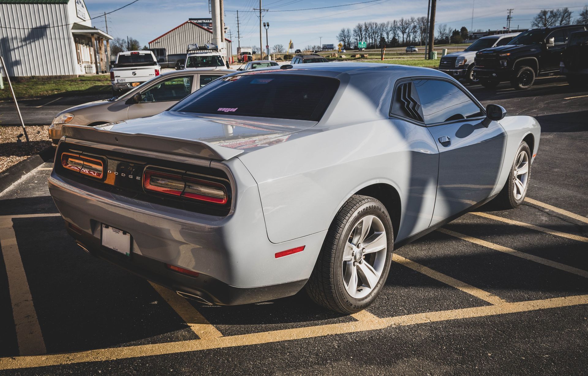 Gray Dodge Challenger parked in a parking lot, sunny day. | Mountain Top Service Center
