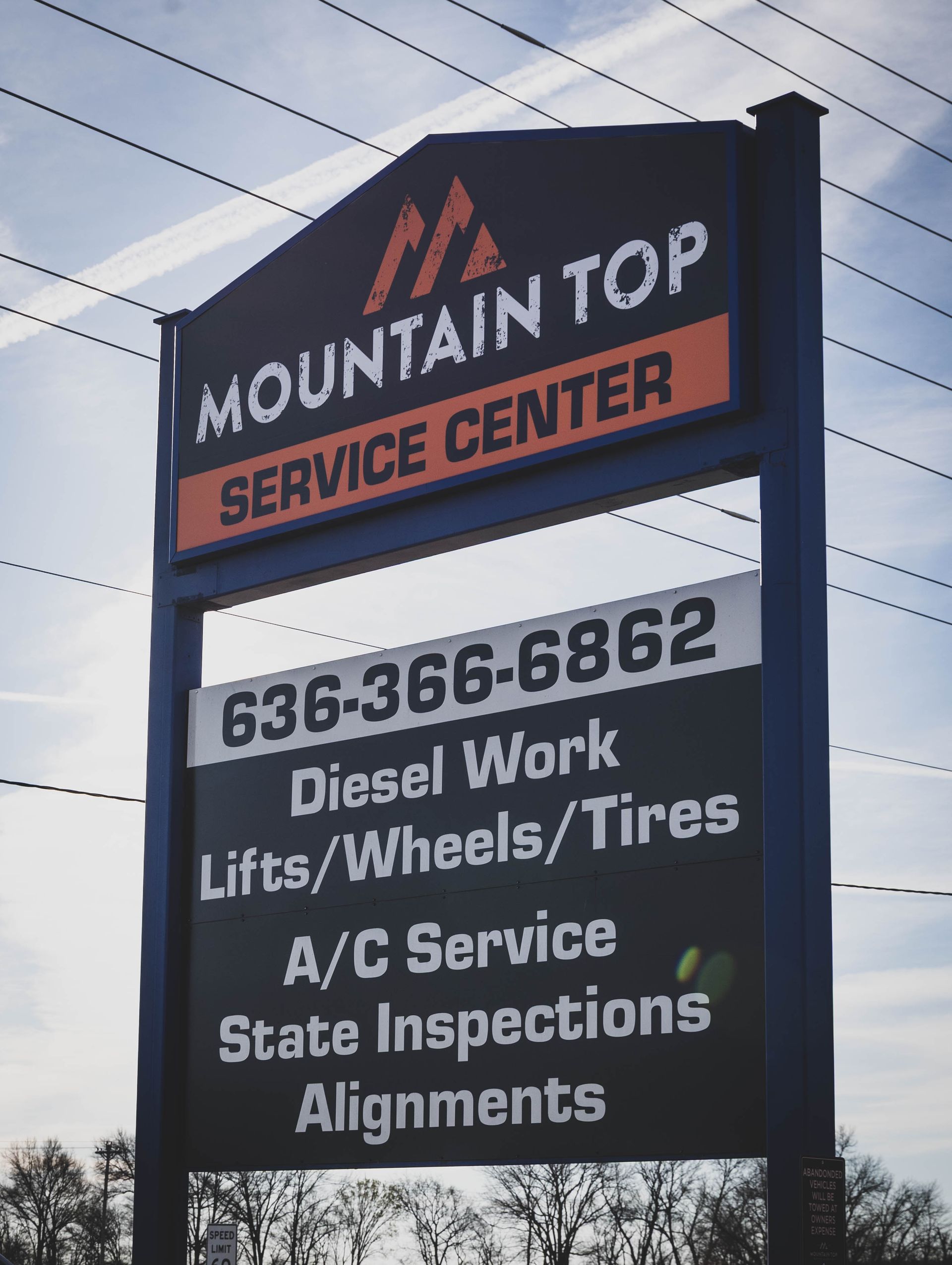 Sign for Mountain Top Service Center with phone number and services offered. | Mountain Top Service Center