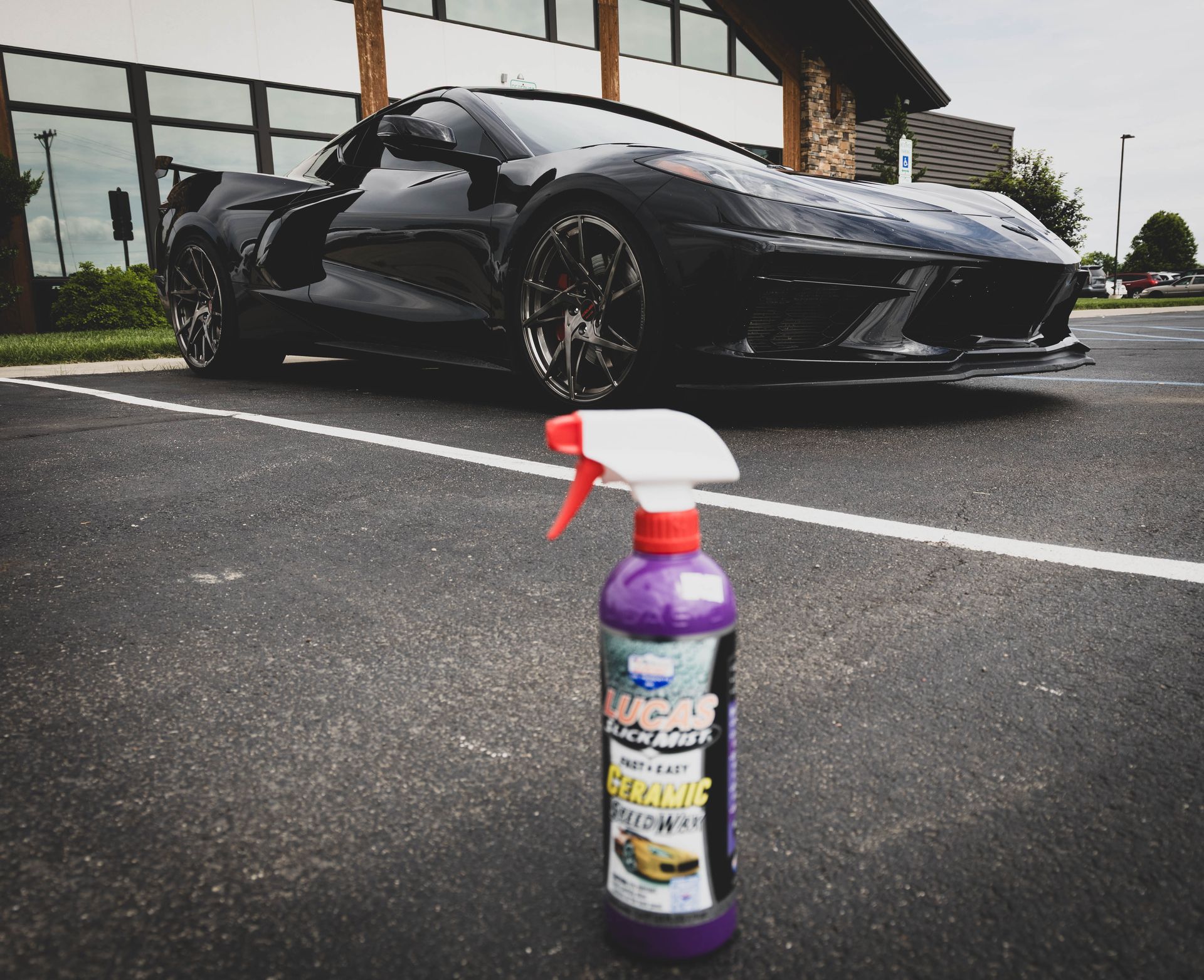 Black sports car parked near a spray bottle in a parking lot. | Mountain Top Service Center