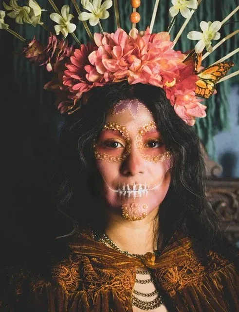 Woman in Day of the Dead makeup and flower crown.
