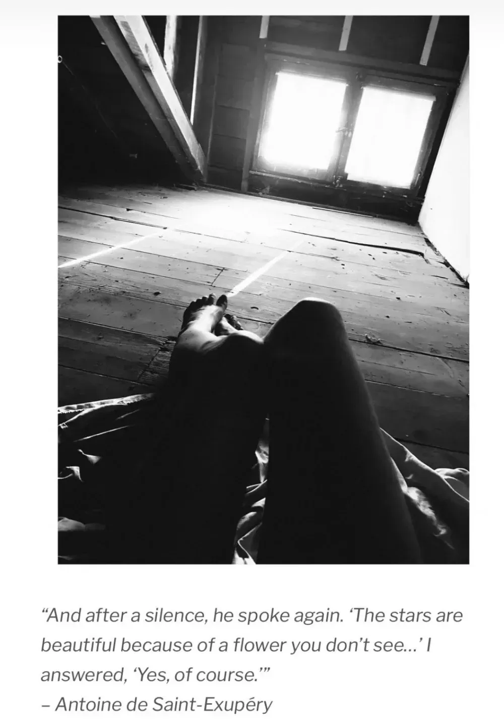 Monochrome photo: person's legs and feet in an attic, text from Antoine de Saint-Exupéry about stars.