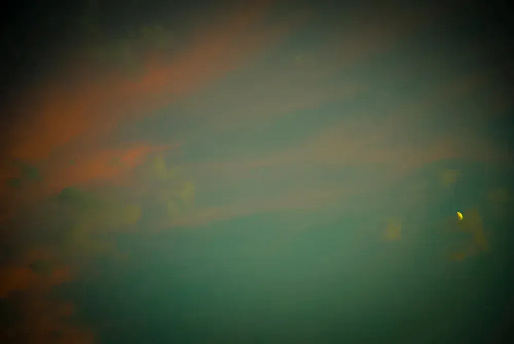 Sunset sky with streaks of orange and turquoise hues.