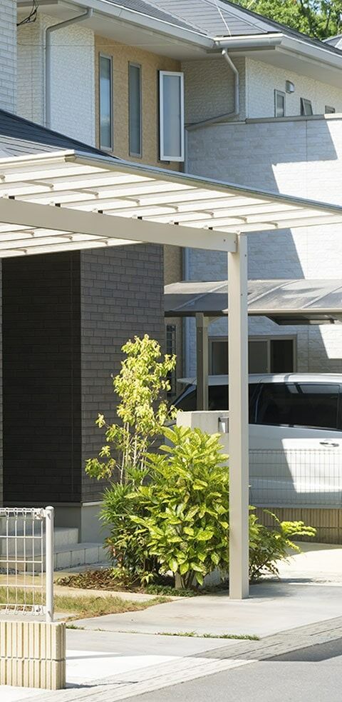 A Car Is Parked Under A Canopy In Front Of A House — Chris Stolk Constructions In Kanahooka, NSW