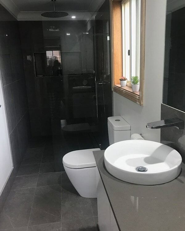 A Bathroom With A Toilet , Sink And Mirror — Chris Stolk Constructions In Kanahooka, NSW