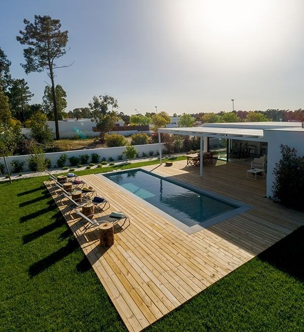 A House With A Large Swimming Pool And A Wooden Deck — Chris Stolk Constructions In Kanahooka, NSW