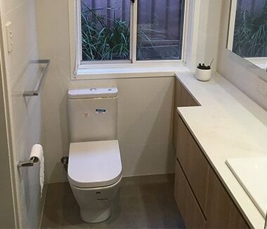 A Bathroom With A Toilet , Sink , Mirror And Window — Chris Stolk Constructions In Kanahooka, NSW