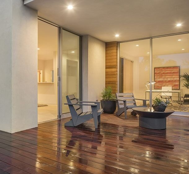 There Are Two Chairs And A Coffee Table On The Deck — Chris Stolk Constructions In Kanahooka, NSW