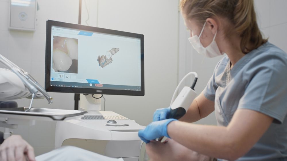 Dentist Using a Digital Scanner on a Patient's Teeth— Bromley's Denture Clinic in Tweed Heads South, NSW