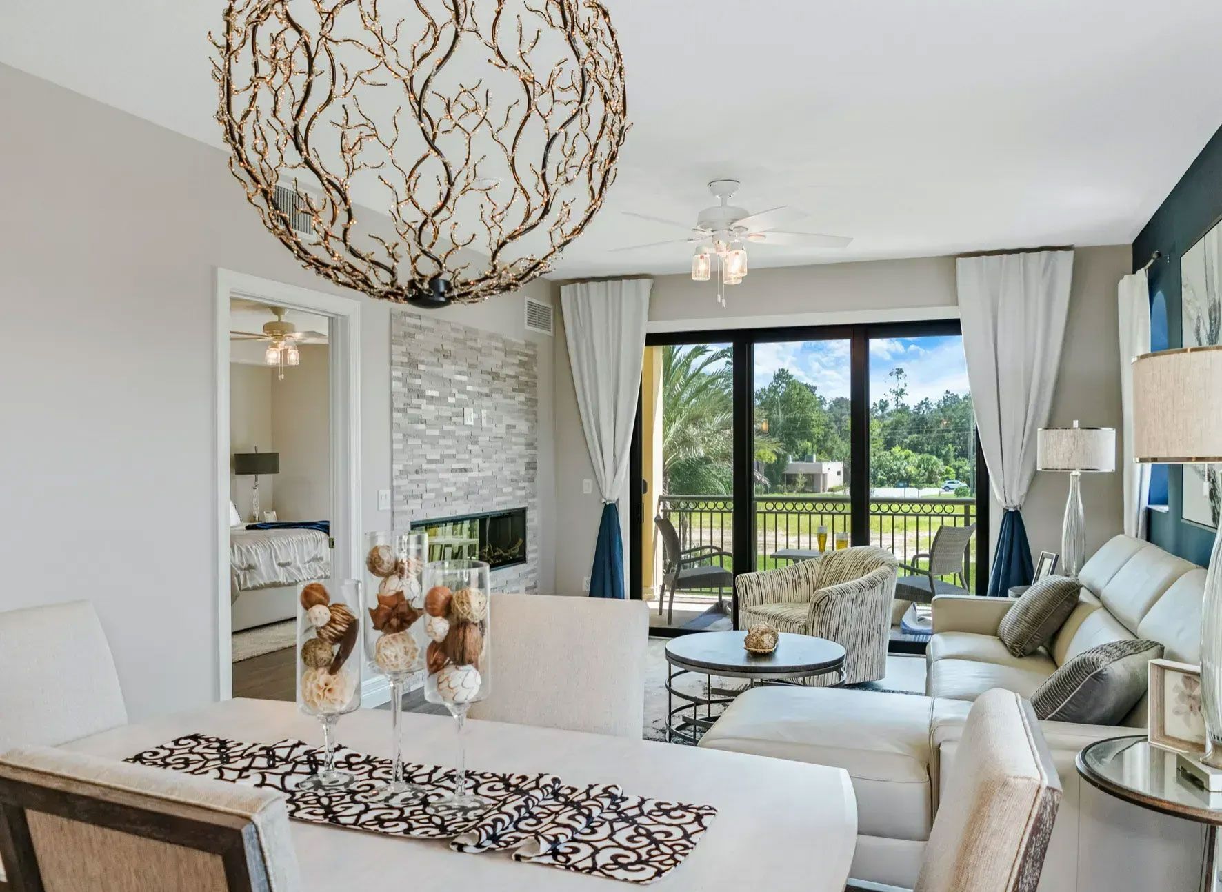 A living room with a dining table and chairs and a couch. A living room with a dining table and chairs and a couch.