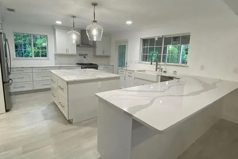 A kitchen with white cabinets and granite counter tops. A kitchen with white cabinets and granite counter tops.