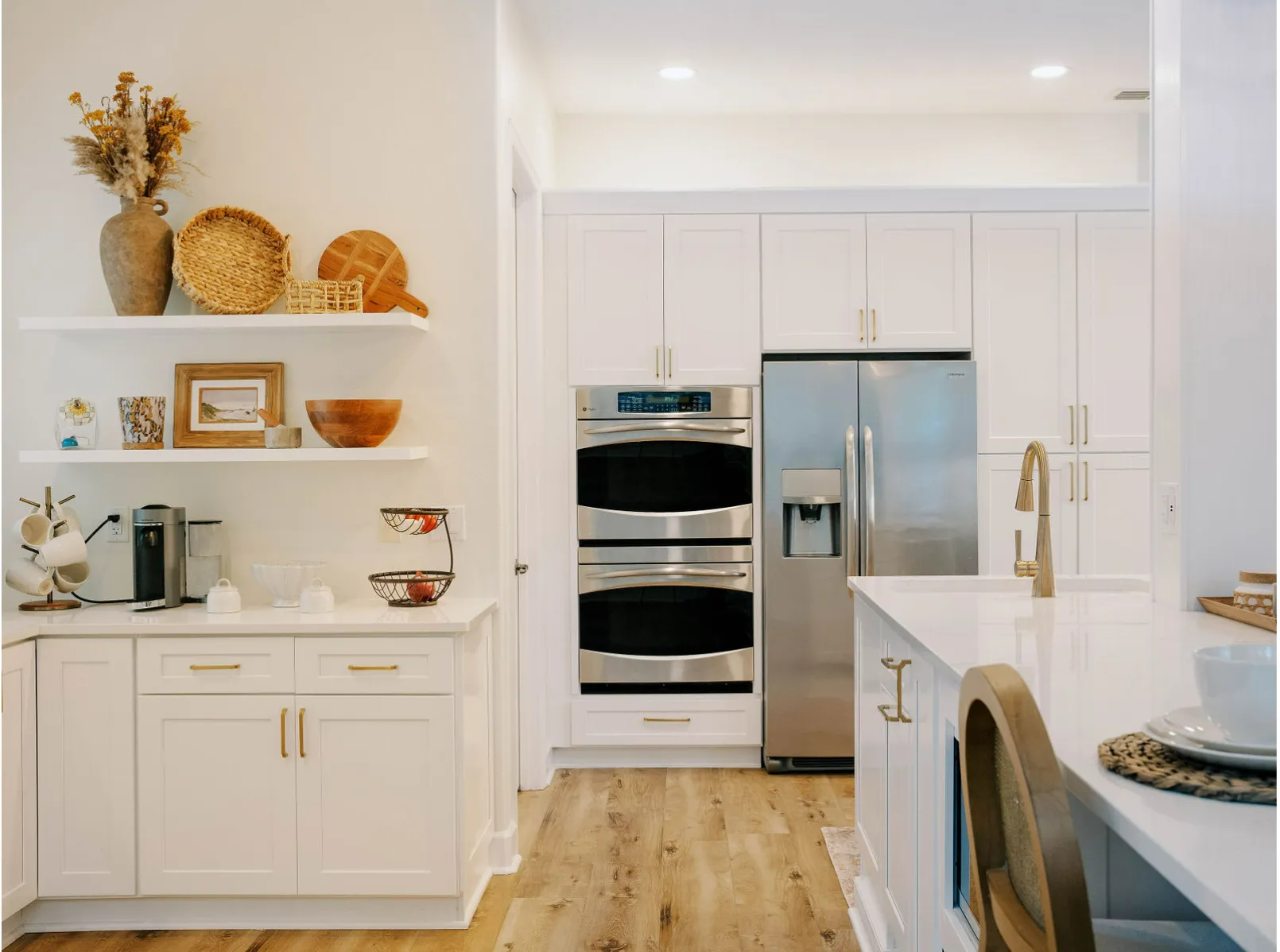 A kitchen with white cabinets and stainless steel appliances.