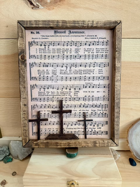 A wooden piece made by Rough Cut Wood that has Blessed Assurance on it.