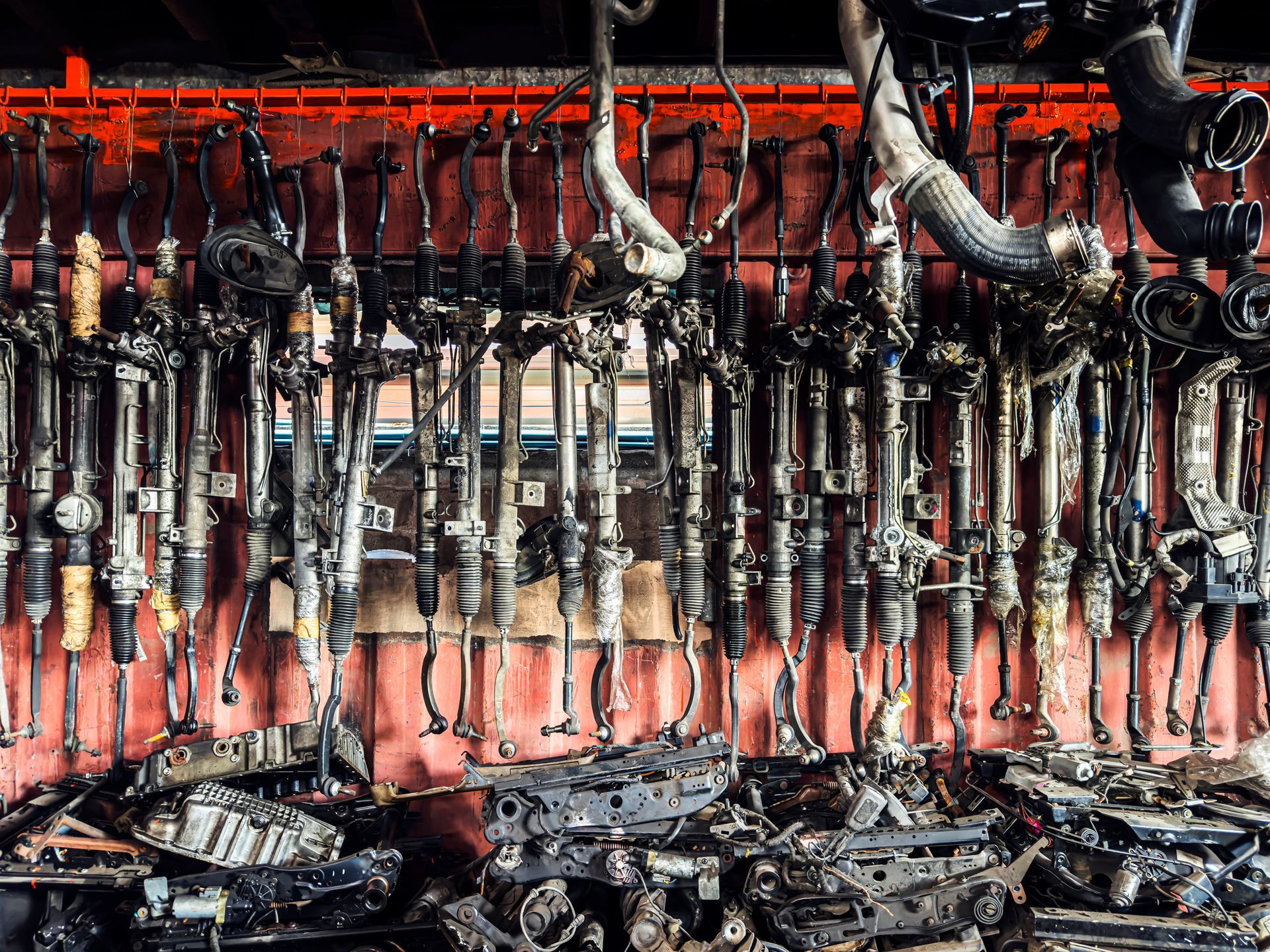 Organised used car parts and engine components in an auto salvage yard.