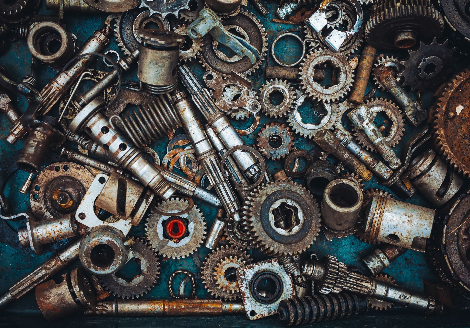 A Heap of mechanical components of car and motor parts.