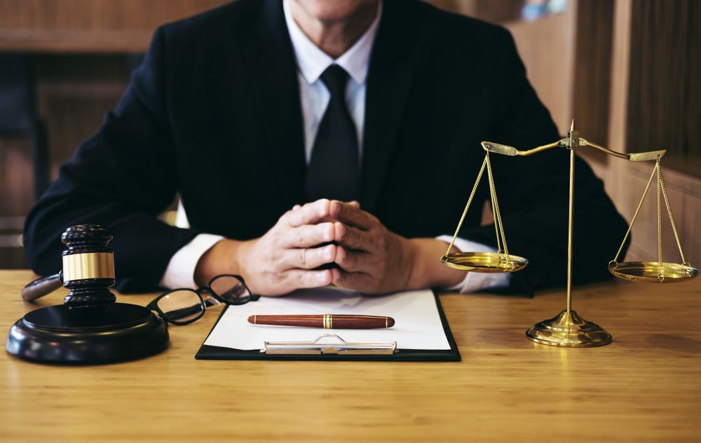Lawyer in Suit at Desk With Gavel, Scales, and Documents — Umbrella Legal in Gosford, NSW