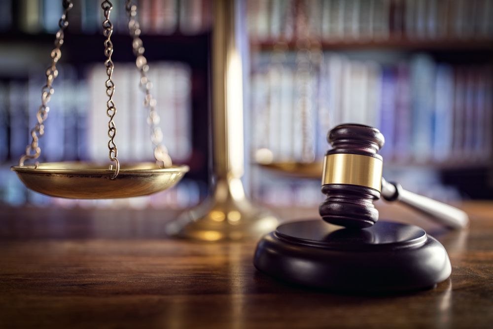 Scales of Justice and Gavel on a Wooden Desk — Umbrella Legal in Cardiff, NSW