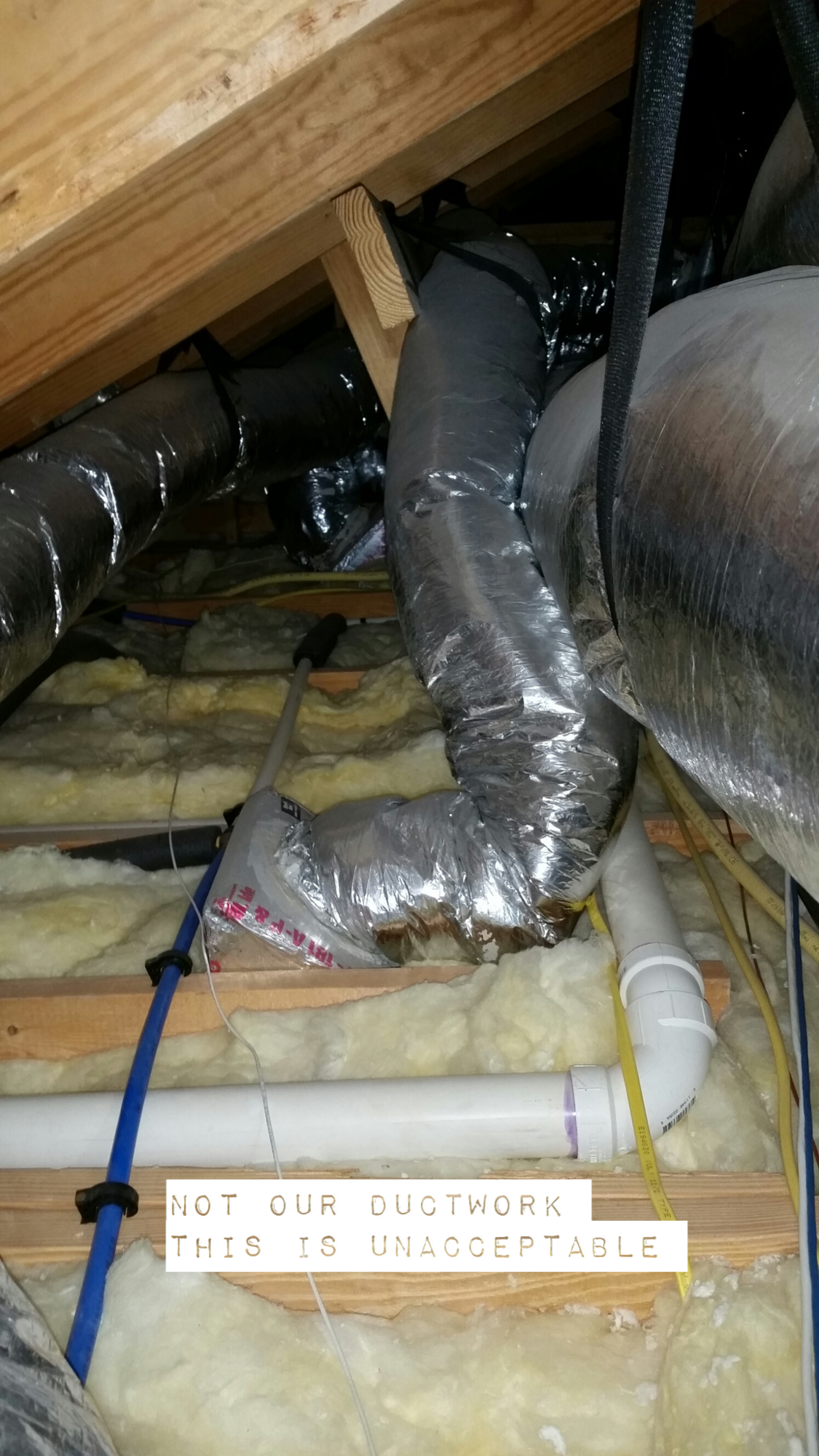 A picture of a ductwork in the attic of a house.