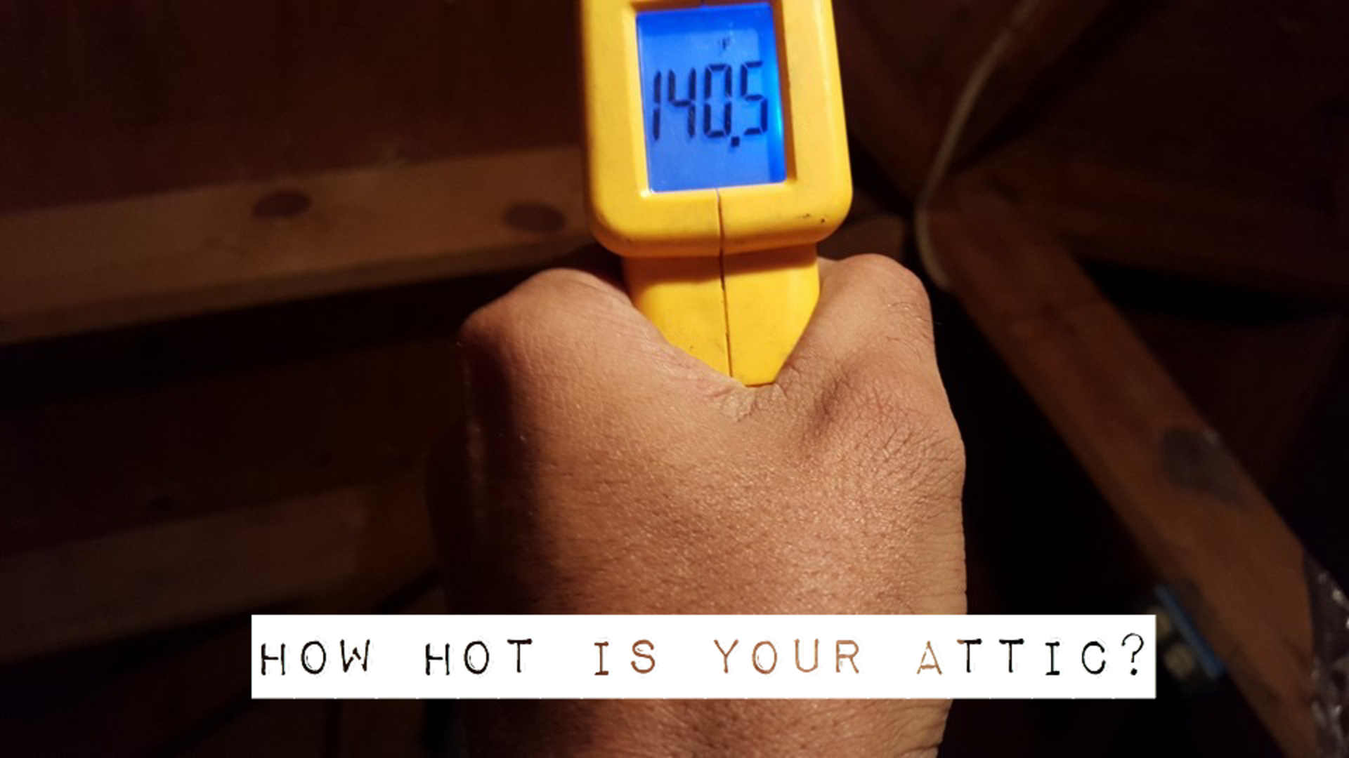 A person is measuring the temperature of their attic with a thermometer