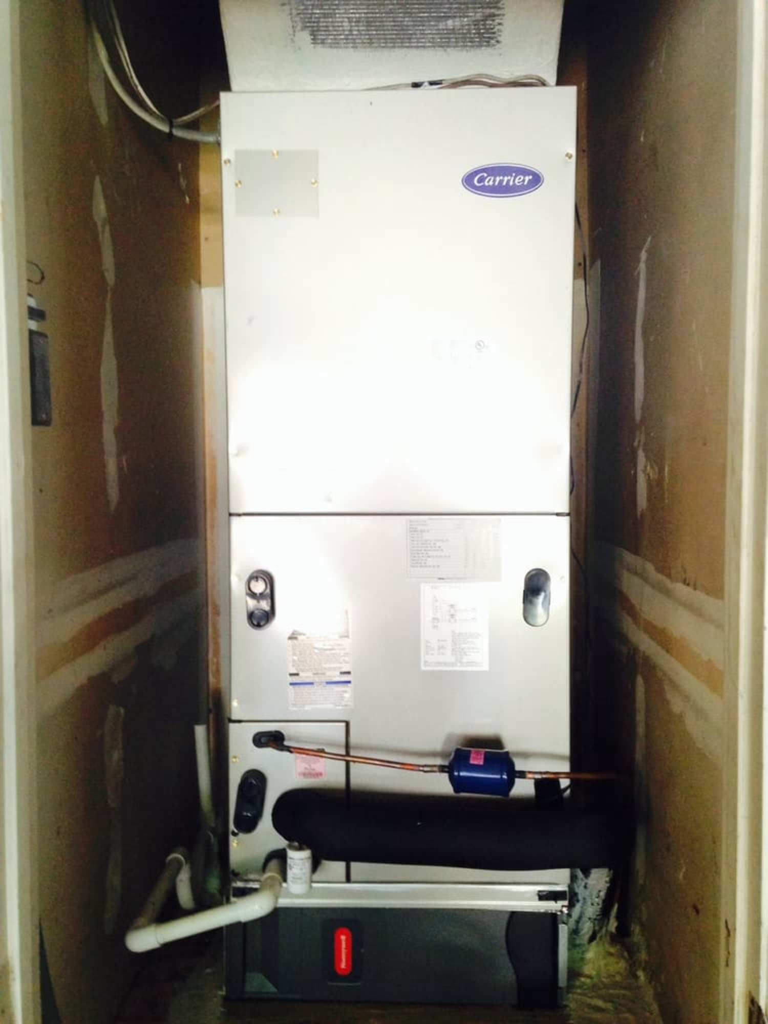 A carrier air conditioner is sitting in a closet
