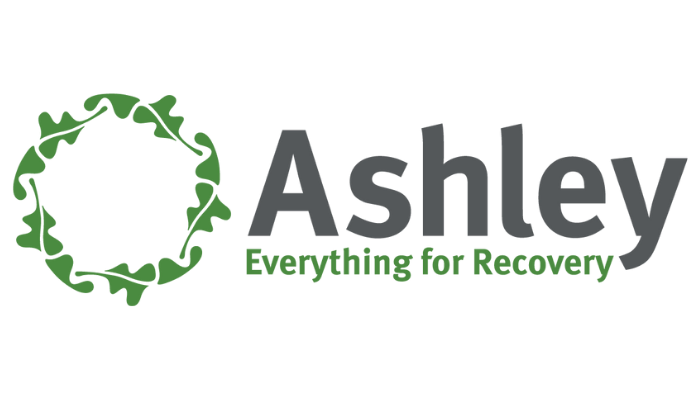 Logo for Ashley Treatment Center, a recovery center, with a green oak leaf circle and gray text.