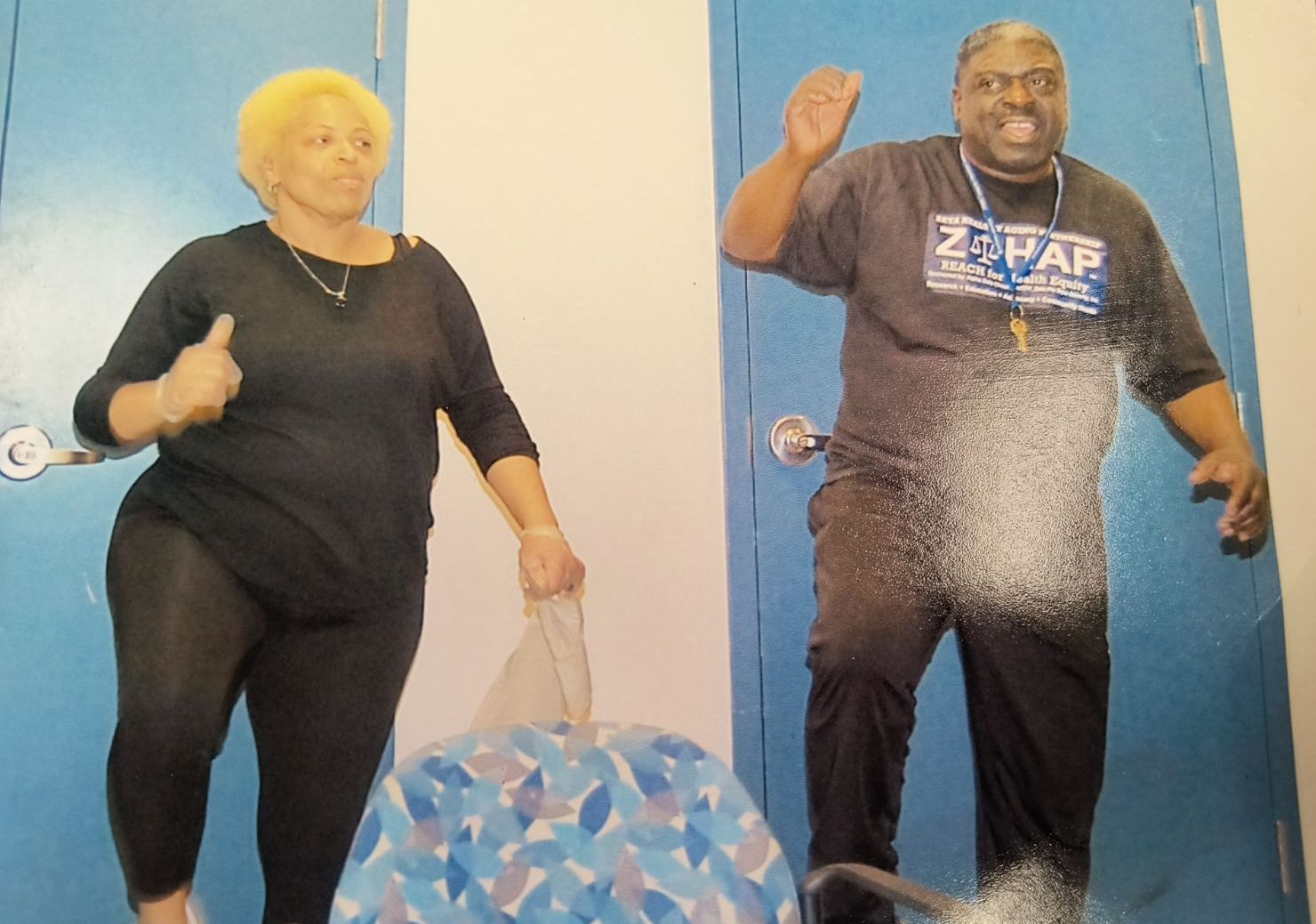 A man wearing a 2pac shirt is standing next to a woman