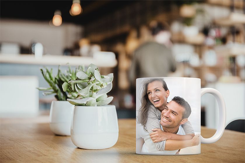 A person holding a frame and a picture with flowers on it