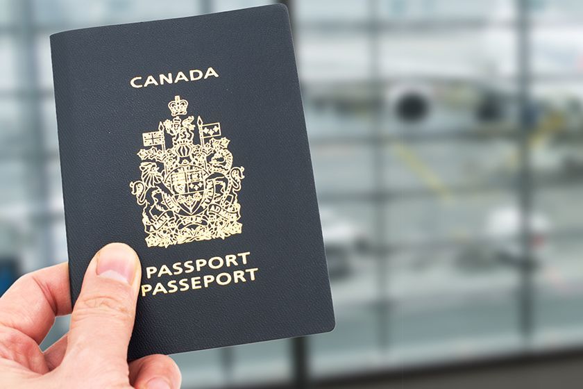 A woman holding a Canadian passport