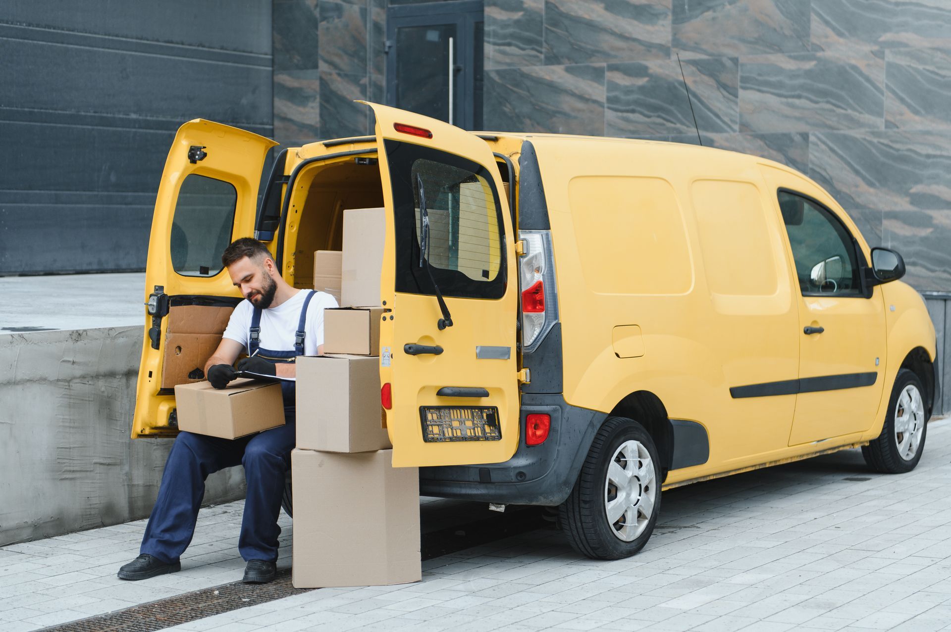 A family is sitting on the porch of their house next to a swimming pool.