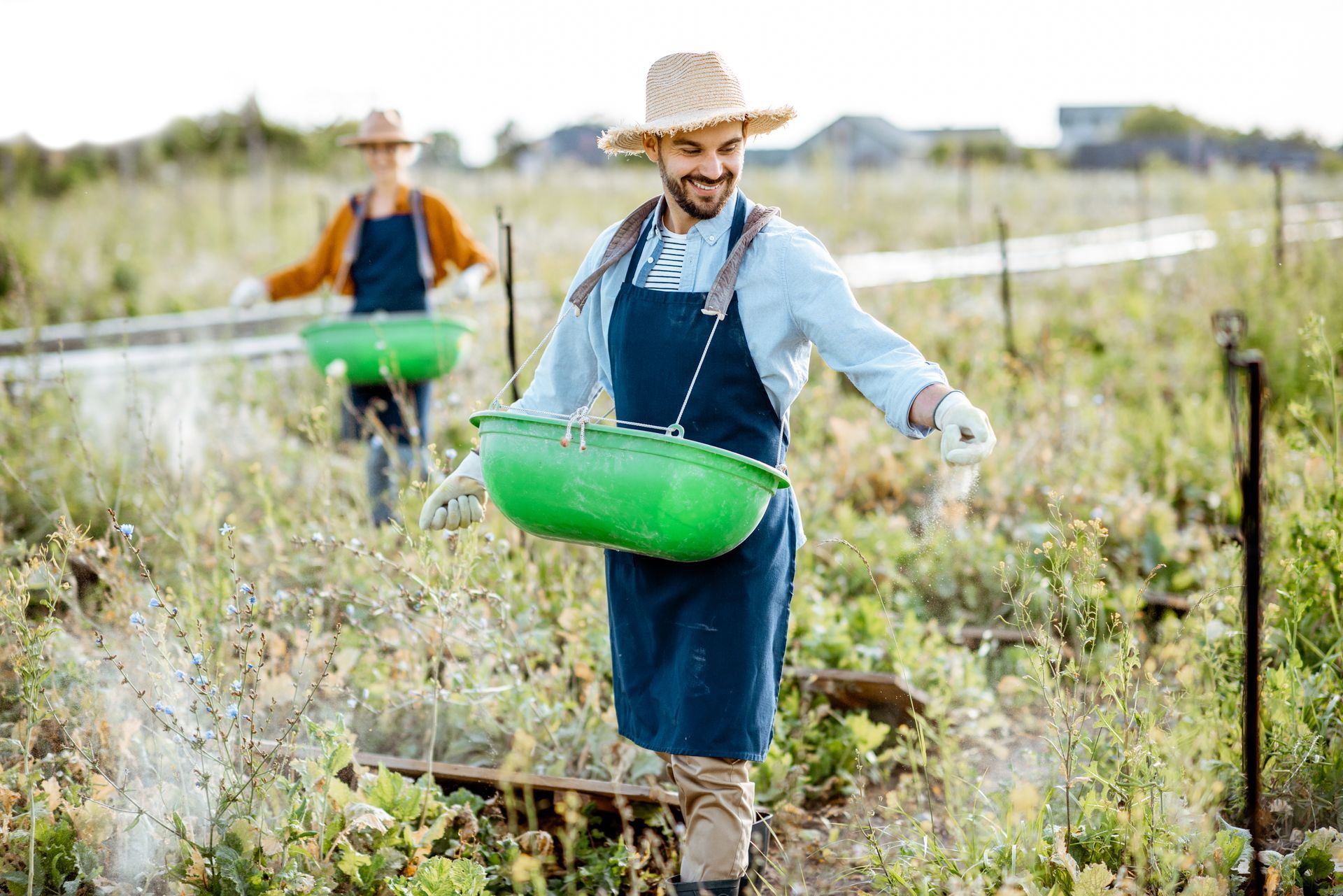 Two men are standing in a kitchen talking to each other.