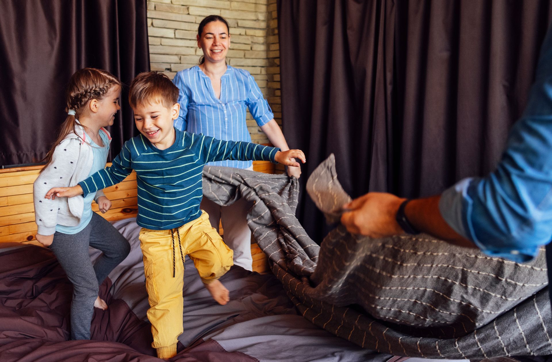 A man and a woman are walking in front of a house holding hands.