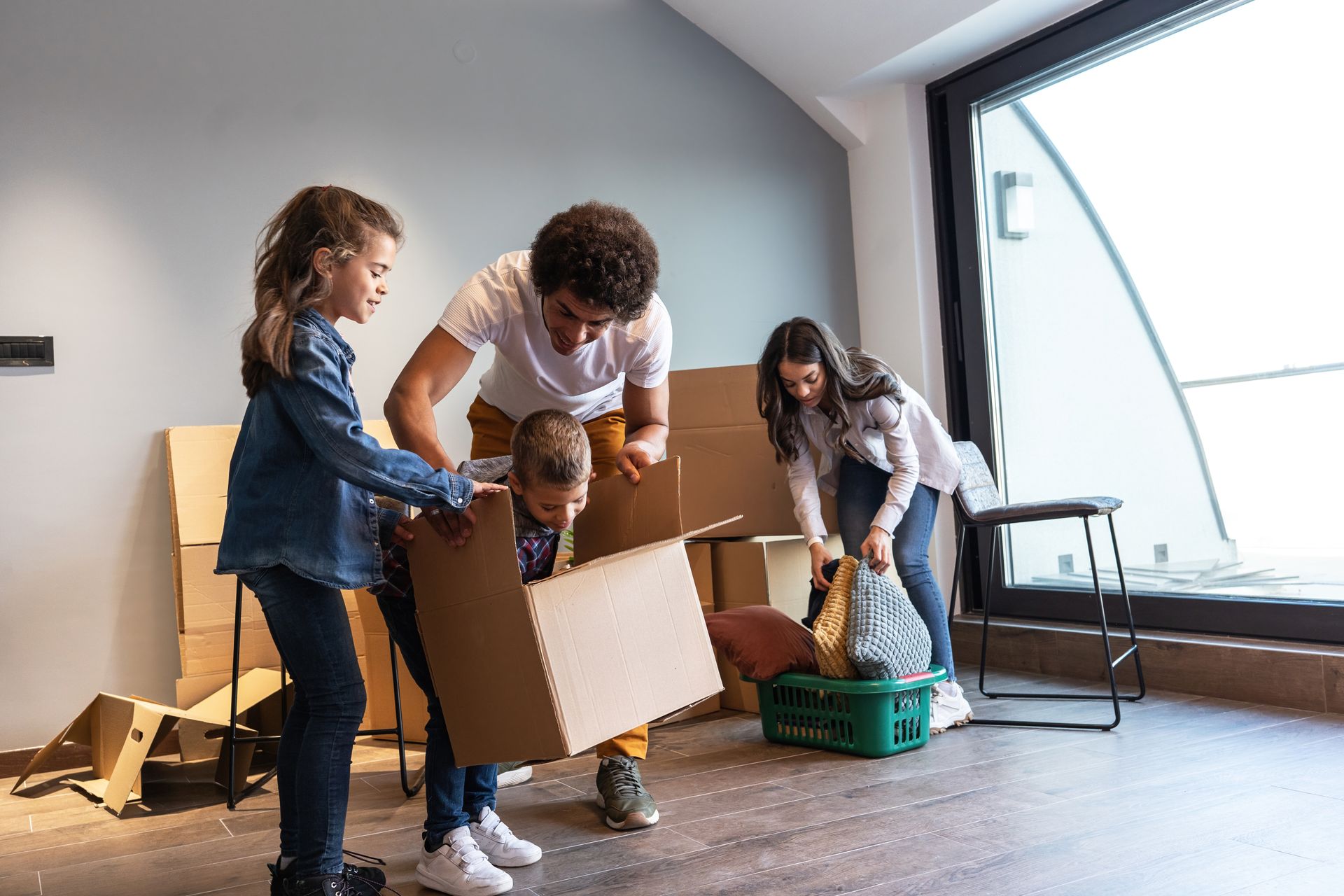 Two men are standing in a kitchen talking to each other.