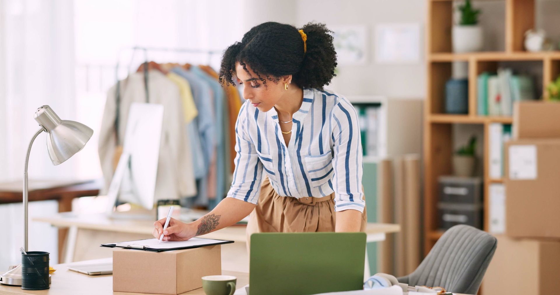 A man and a woman are walking in front of a house holding hands.