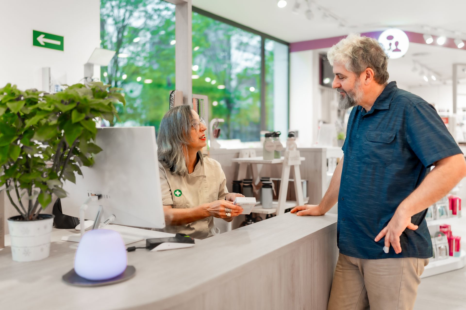 A man and a woman are walking in front of a house holding hands.