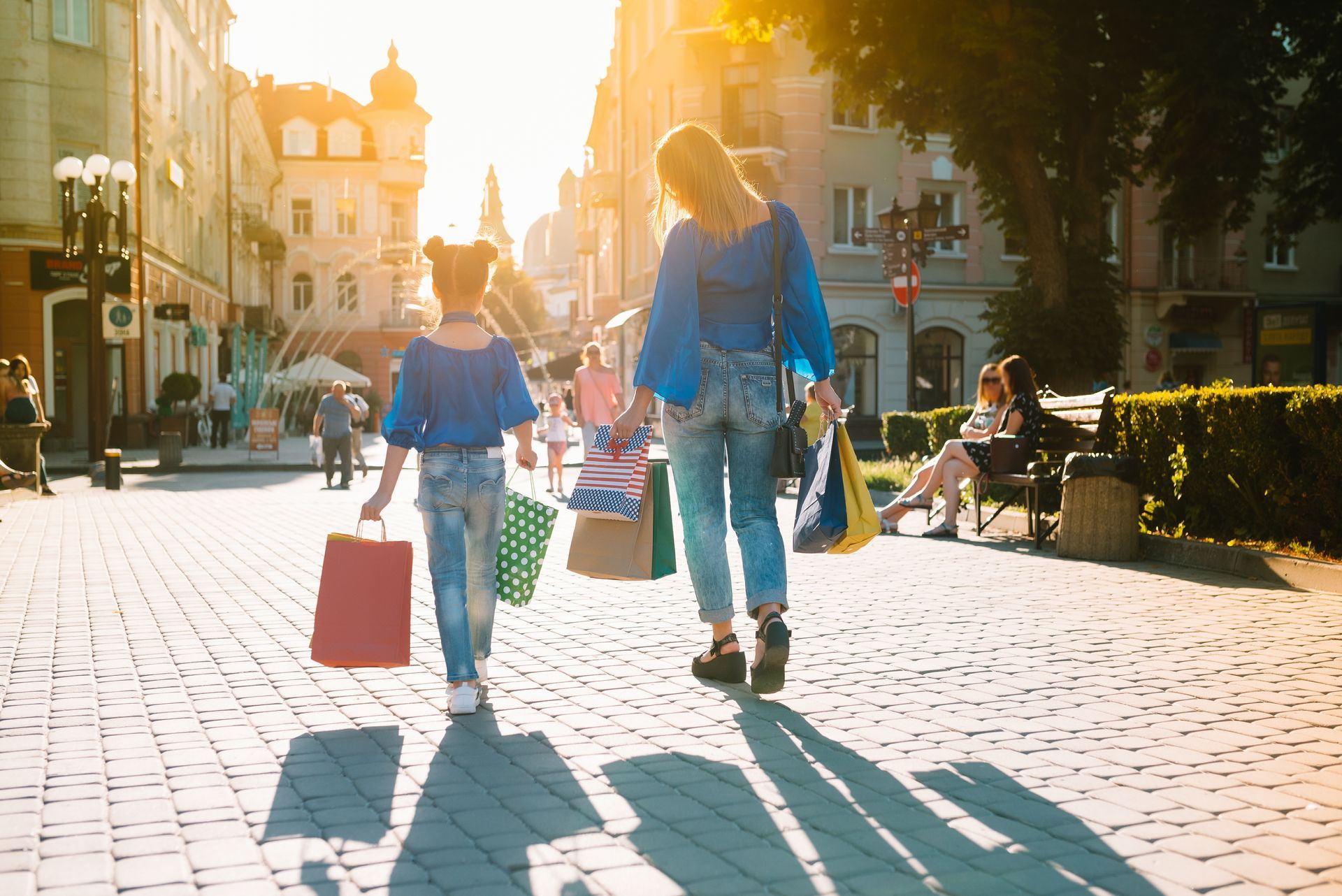 A family is moving into a new home carrying boxes.