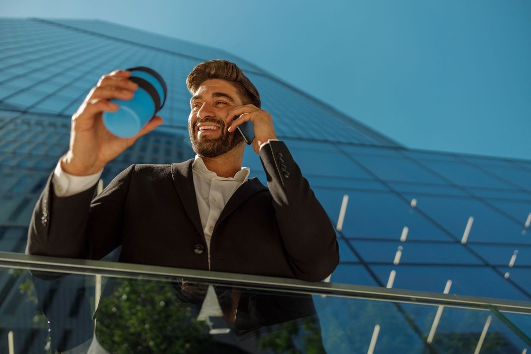 A man is sitting at a desk using a laptop computer.