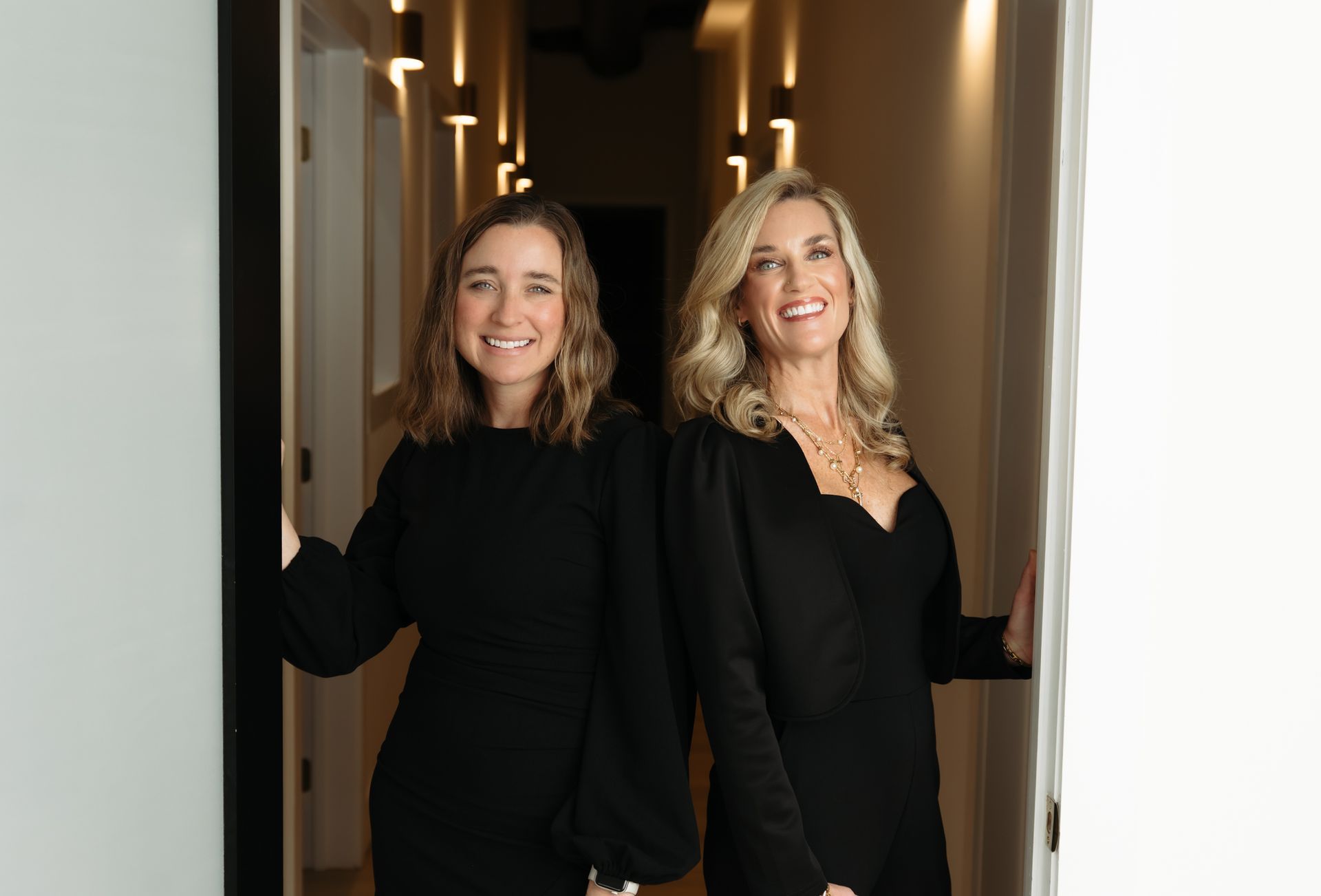 a woman is cleaning her face with a white towel .