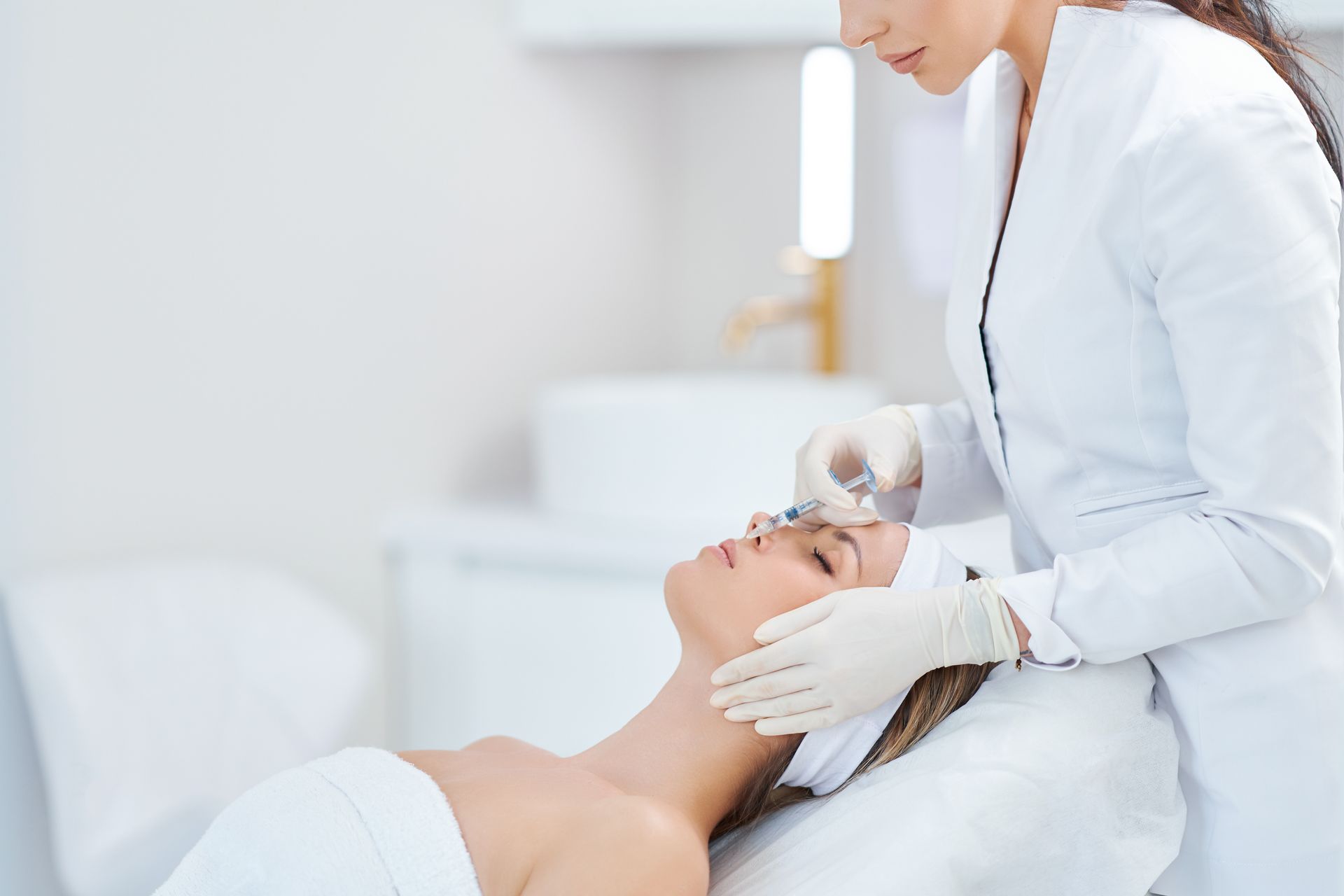 a woman is getting a facial treatment at a beauty salon .