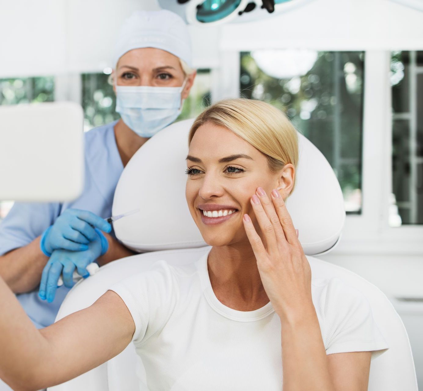 A woman is taking a selfie in a dental chair.