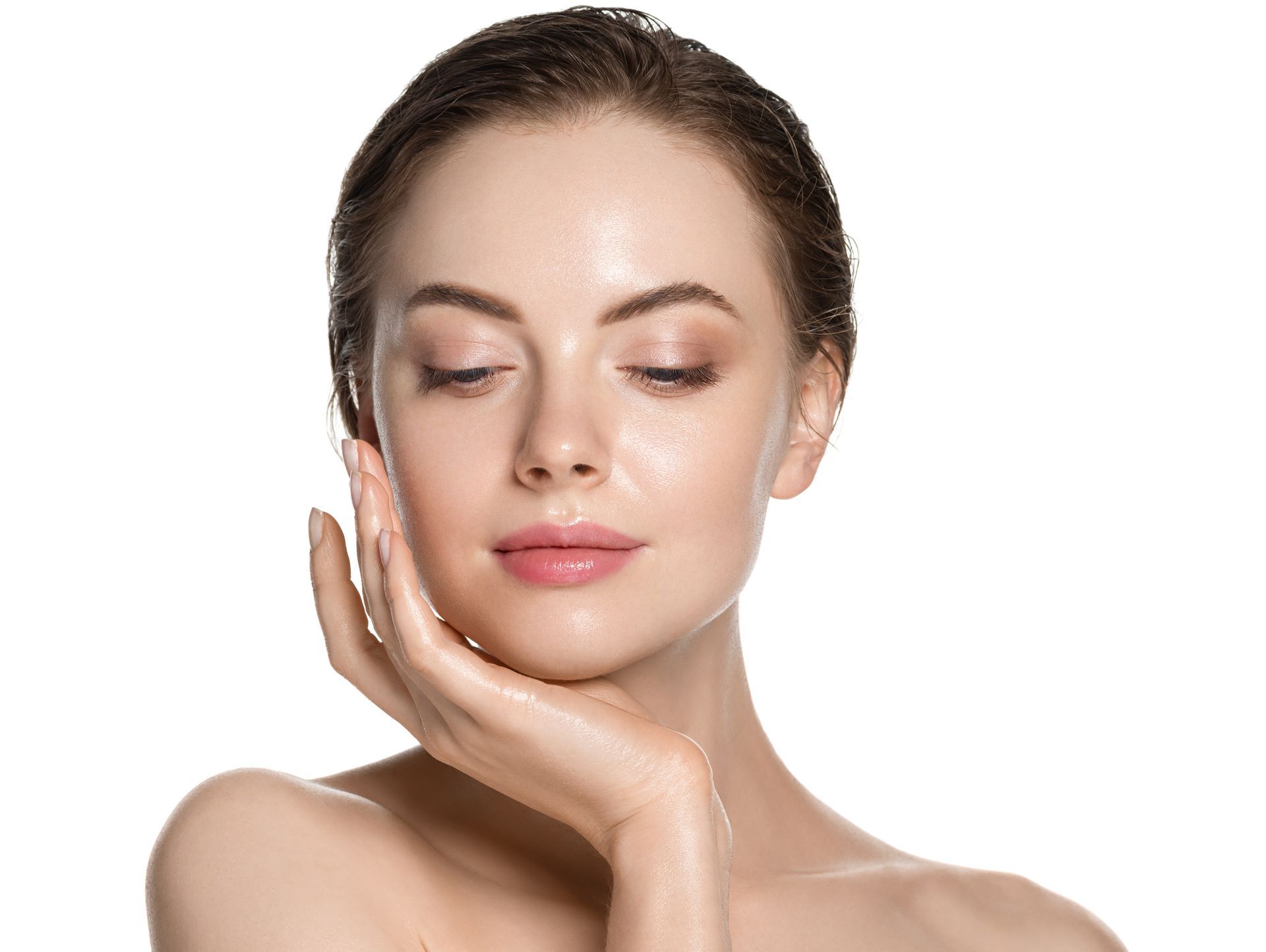 A close up of a woman 's face with her hand on her chin.