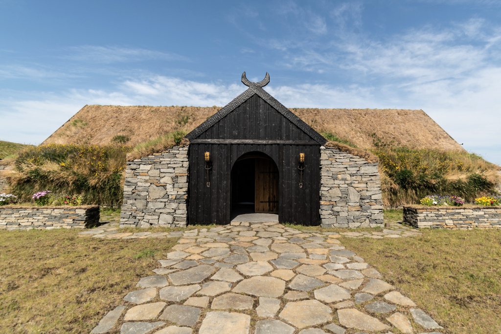 A black building with a stone walkway leading to it.