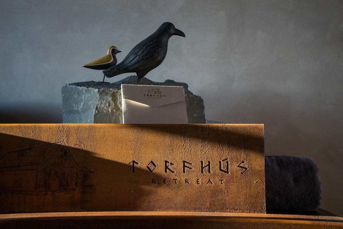 A statue of two birds sitting on top of a wooden box.