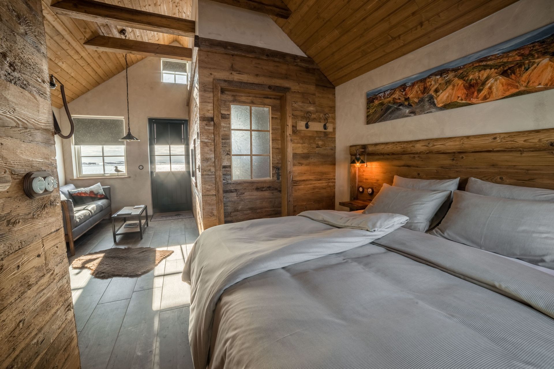 A bedroom with a bed and a couch in it.
