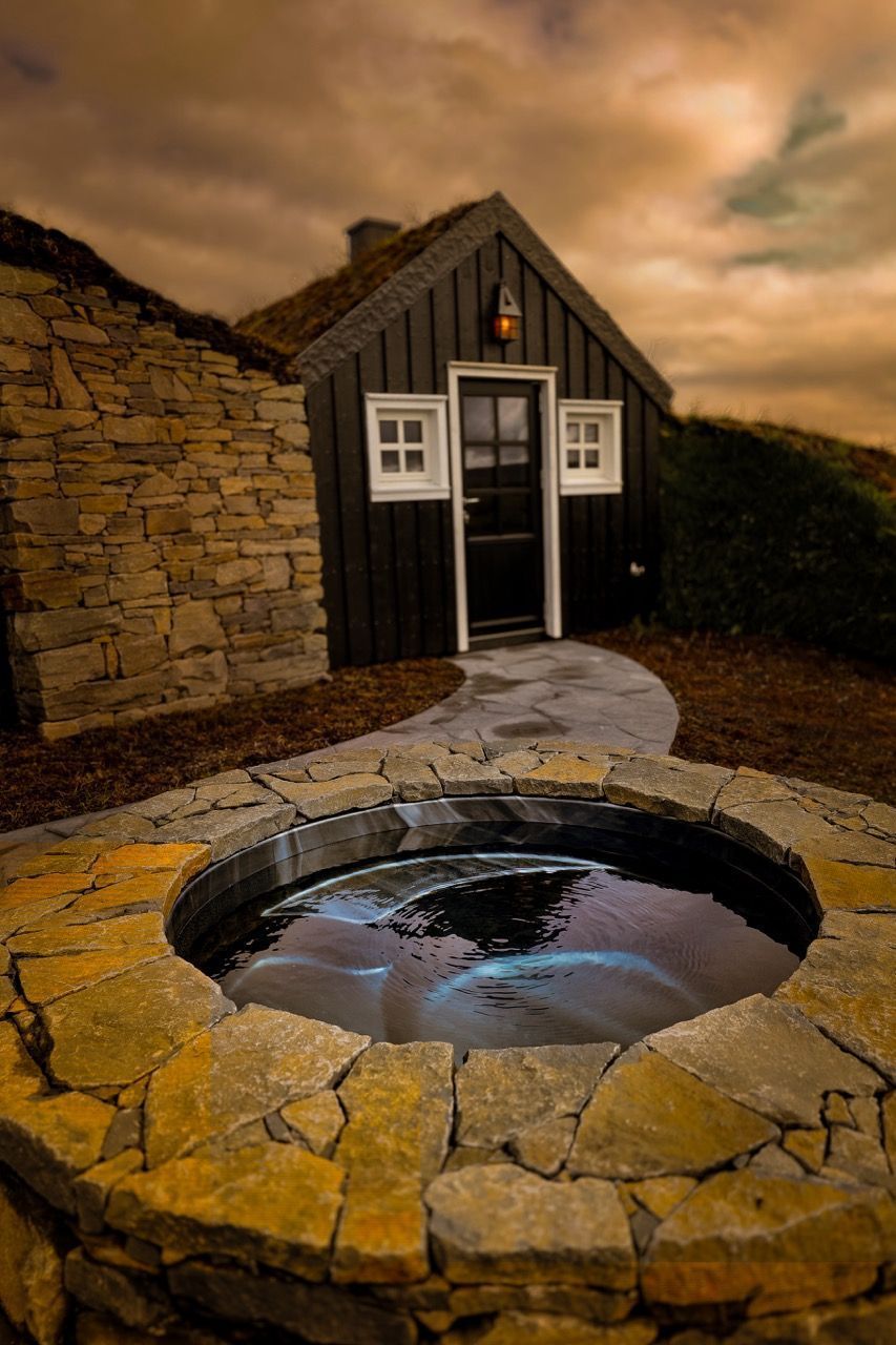 A black house with a stone walkway leading to it