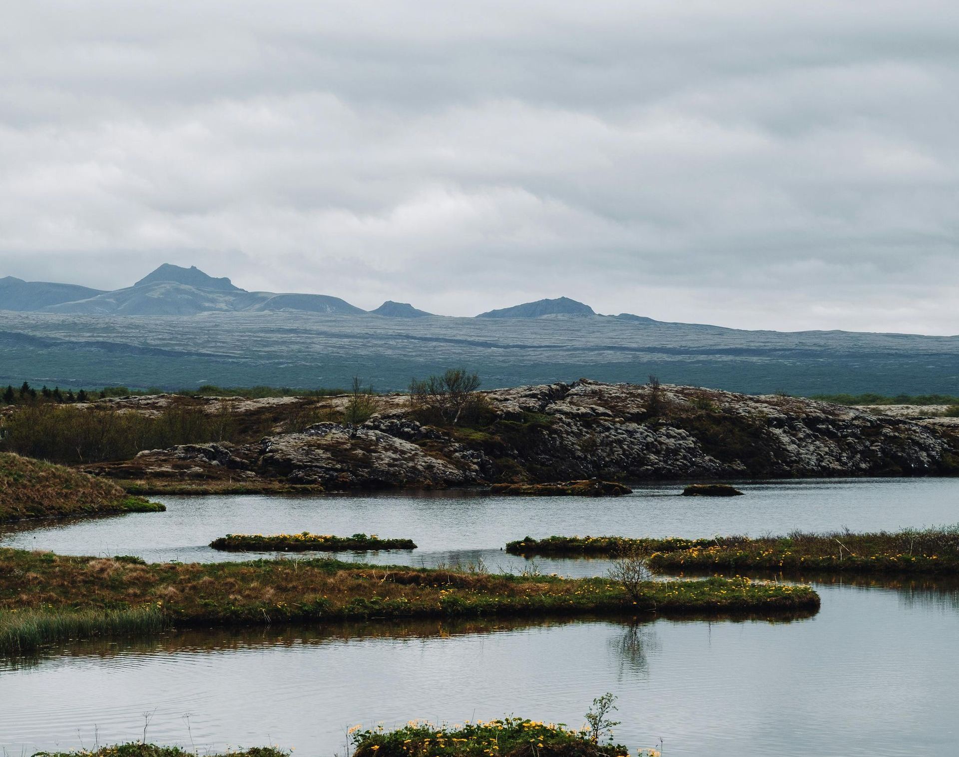 A large body of water with mountains in the background